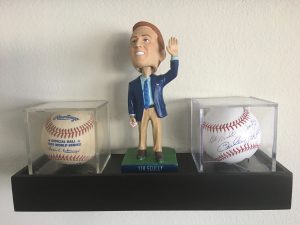 Just above my computer monitor in my home office sits this shelf, which includes: a 1981 World Series official ball, given to me by my aunt in 1981; a Vin Scully bobblehead; and a ball signed by Garvey, Lopes, Russell, and Cey — a birthday gift from my wife this year.